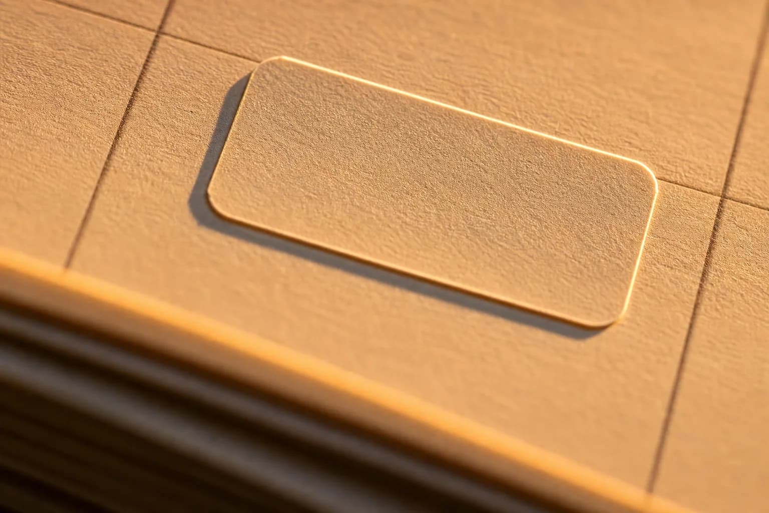 A blank payment-date sticker rests on a paper calendar in warm golden sunlight.